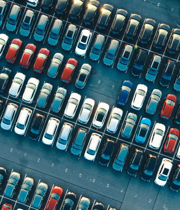 tight coloured car rows on parking area vertical upper view tight coloured finished car rows on warehouse parking area with modern lighting on sunny summer day vertical upper view